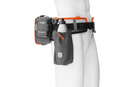 A Husqvarna Battery belt FLEXI with multiple compartments, designed to hold and power various outdoor tools. The belt features adjustable straps, two main orange battery holders, a black pouch on the left, and a connected power module on the right—perfect for maintaining lawns efficiently.