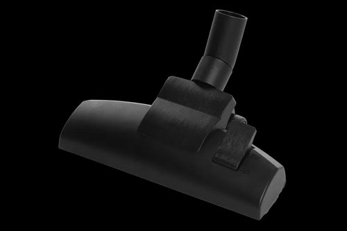 The Husqvarna Floor Nozzle by Husqvarna is a black, rectangular vacuum cleaner attachment with a circular pipe connector at the top for attaching to the vacuum cleaner hose. Ideal for vacuuming floors, it includes a brush adjustment switch. The product is shown against a white background.