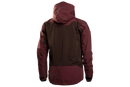 The Husqvarna Xplorer Shell Jacket, available in grape purple and aubergine purple for women, is crafted from 4-way stretch material. It features a front zipper, two zippered pockets, and a logo on the left sleeve. The chest showcases the text "BUSHMAN" vertically. With its wind and water repellent qualities, it also includes orange-accented zippers and a removable hood for versatility.