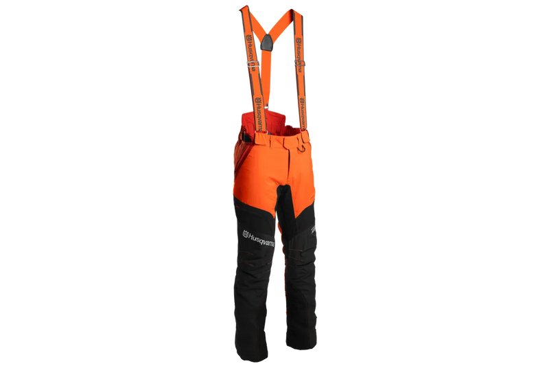 A pair of Husqvarna Arbor Waist trousers, Technical Extreme, in orange and black with attached suspenders designed for climbing and working in trees. These trousers feature multiple pockets, reinforced knee areas, and adjustable straps branded with "Husqvarna." The rugged design offers safety, agility, and functionality for demanding tasks.