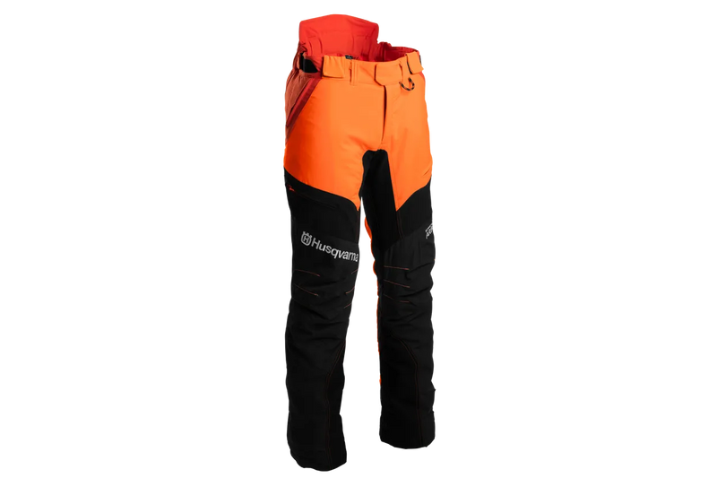 A pair of Husqvarna Arbor Waist trousers, Technical Extreme, in orange and black with attached suspenders designed for climbing and working in trees. These trousers feature multiple pockets, reinforced knee areas, and adjustable straps branded with "Husqvarna." The rugged design offers safety, agility, and functionality for demanding tasks.