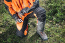 An image of Husqvarna Technical Extreme Waist trousers, high-visibility orange and black protective work pants with adjustable suspenders. These pants, made by Husqvarna, feature Cordura reinforcement at the knees and multiple pockets. The suspenders are adjustable and include reflective strips for enhanced visibility, making them ideal for forest work.
