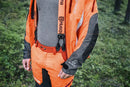 An image of Husqvarna Technical Extreme Waist trousers, high-visibility orange and black protective work pants with adjustable suspenders. These pants, made by Husqvarna, feature Cordura reinforcement at the knees and multiple pockets. The suspenders are adjustable and include reflective strips for enhanced visibility, making them ideal for forest work.
