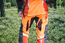 An image of Husqvarna Technical Extreme Waist trousers, high-visibility orange and black protective work pants with adjustable suspenders. These pants, made by Husqvarna, feature Cordura reinforcement at the knees and multiple pockets. The suspenders are adjustable and include reflective strips for enhanced visibility, making them ideal for forest work.
