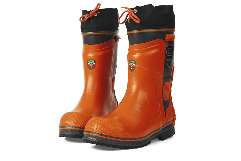 A pair of bright orange Husqvarna Protective boots - Functional 24 with black accents around the top edges and soles. The boots have a lace-up feature and reflective patches near the top. There's a Husqvarna logo on the side along with some certification marks, making them essential accessories for any rider. The soles appear thick and sturdy.