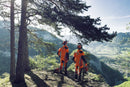 Displayed is the "Husqvarna Extreme Forest Jacket," an orange and black outdoor jacket with gray accents and reflective strips. It features a high collar, long sleeves, ventilation openings for added comfort, and zippered pockets. The brand name "Husqvarna" is visible on the chest.