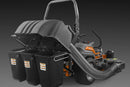 A Husqvarna PZ/Z500X Series riding lawn mower equipped with the Husqvarna 3 Bin Collector with Blower attached to the rear for grass collection. The mower features a sturdy frame, a high-back seat, and a roll bar. It has a hose connecting the mower deck to the 3 Bin Collector for efficient grass transfer.