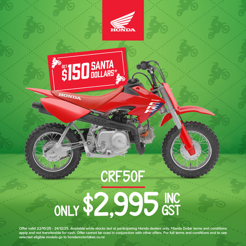 The Honda CRF50F kids bike, featuring a red frame accented with blue and white graphics, sports a small, lightweight build equipped with knobby tires for off-road adventures. The design includes a visible exhaust pipe towards the rear and components like an adjustable throttle, seat, and handlebars tailored for young riders.