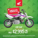 A Honda CRF50F Pink/White kids bike with a white frame, a pink seat, and purple graphics on the side. This model features thick, knobby tires suitable for off-road riding, handlebars equipped with hand guards, and a small, compact size perfect for young riders.