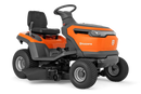 The Husqvarna Battery TS 100i Tractor, in orange with a black seat and steering wheel, offers ergonomic comfort and features robust wheels with visible blade housing. The brand logo is prominently displayed on the side, ensuring efficient mowing with every use.
