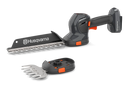 The Husqvarna Aspire™ Shrub Shear 18V (Skin) is a sleek, modern black and orange battery-operated hedge trimmer with an 18V POWER FOR ALL ALLIANCE system. It includes a detachable blade and interchangeable Shrub Shear attachment, displayed on a plain white background.