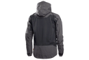 The Husqvarna Xplorer Shell Jacket Charcoal Black - Women by Husqvarna is a dark gray, hooded outdoor jacket. This windproof jacket features a full front zipper, zippered pockets, and subtle branding on the chest. It has long sleeves, adjustable ventilation, and a slightly fitted design, making it suitable for various weather conditions.