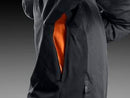 The Husqvarna Xplorer Shell Jacket - Forest Green is showcased on an invisible mannequin. Crafted from water-resistant shell material, this dark green jacket features a hood, zippered chest and side pockets, and eye-catching orange accents. It also proudly displays the Husqvarna logo stitched on both the chest and arm, while adjustable ventilation provides added comfort.