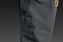 The Husqvarna Xplorer Shell Jacket Charcoal Black - Women by Husqvarna is a dark gray, hooded outdoor jacket. This windproof jacket features a full front zipper, zippered pockets, and subtle branding on the chest. It has long sleeves, adjustable ventilation, and a slightly fitted design, making it suitable for various weather conditions.