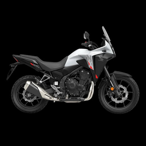 The Honda NX500, a sleek and modern motorcycle by Honda, showcases a silver and black color scheme with programmed fuel injection. It features a prominent windshield, angular design elements, and alloy wheels. The side profile accentuates its sporty and aerodynamic build.