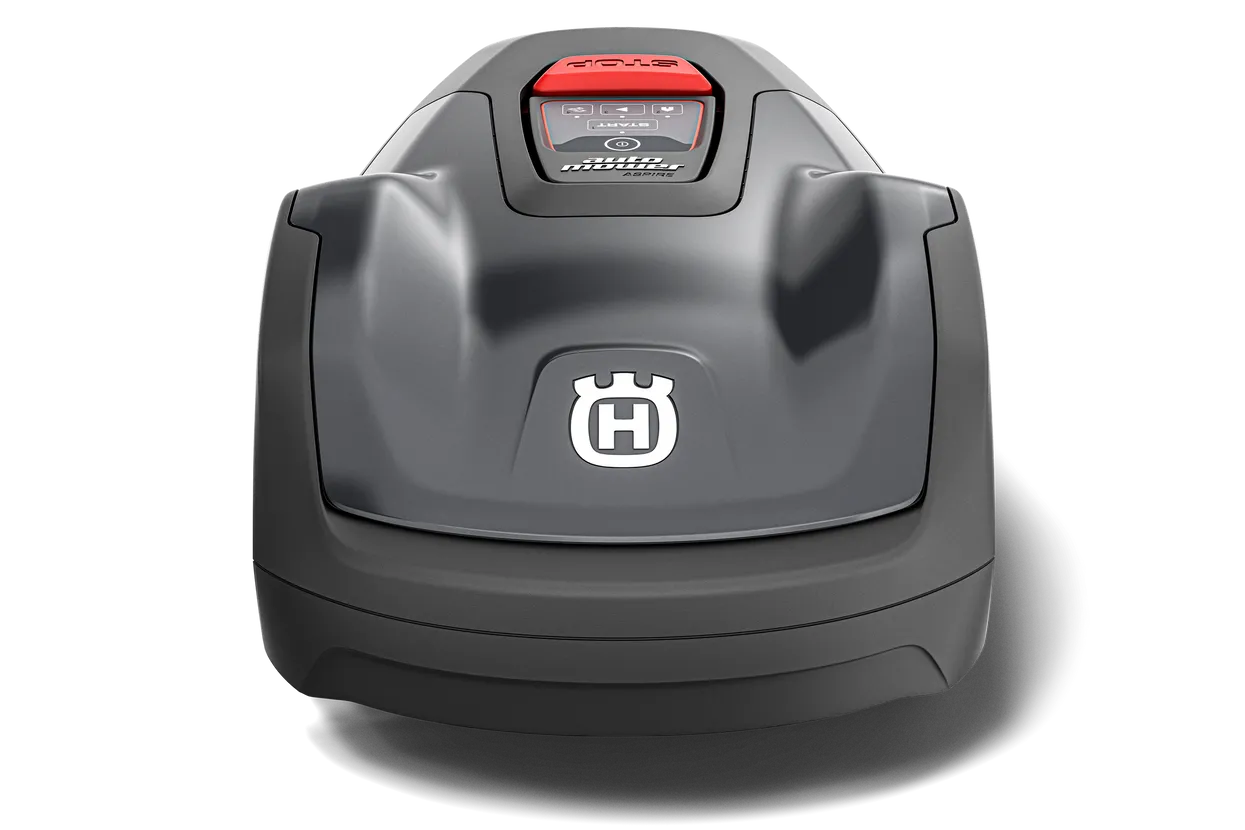 Image of a black Husqvarna Automower® Aspire™ R4 - Install Kit Included with a red button on top, positioned next to a spool of wire, plastic boundary pegs, and several electronic connectors. The mower features a sleek, modern design and a logo with the letter 