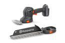 The Husqvarna Aspire™ Shrub Shear 18V (Skin) is a sleek, modern black and orange battery-operated hedge trimmer with an 18V POWER FOR ALL ALLIANCE system. It includes a detachable blade and interchangeable Shrub Shear attachment, displayed on a plain white background.