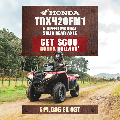 A red Honda TRX420FM1 with large black tires, black racks on the front and back, and a black seat. The rugged 4WD manual Honda TRX420FM1 is shown against a plain white background.