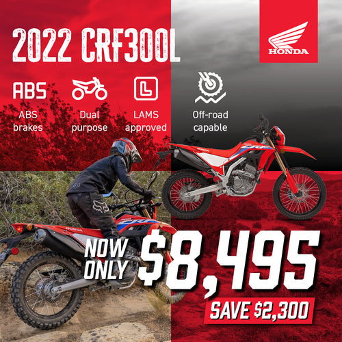 The Honda CRF300 Rally is a red and black adventure motorcycle with a windscreen, off-road tires, and blue & white accents. Designed for rugged terrain, it is highlighted on a plain white background, showcasing its sleek design and impressive off-road performance.