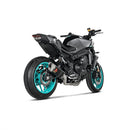 The Full System MT-09/FZ-09 2024 by AKRAPOVIC features a carbon-fiber muffler with the brand's logo, boasting a sleek black cylindrical design and four metallic pipes, delivering a sporty racing sound.