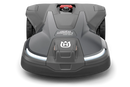 The Husqvarna Automower 430X NERA is a sleek, grey robotic lawn mower featuring two large wheels at the rear and two smaller wheels at the front. It boasts a red stop button on top, LED headlights, and proudly displays the Husqvarna logo on the front. With its modern design, this mower is equipped with object avoidance technology and can be conveniently controlled via the Automower Connect app.