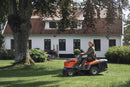 The Husqvarna Battery TC 100i Tractor in bright orange and black features a steering wheel, comfortable seat, efficient collecting system, and durable tires. It boasts sleek lines and a modern design for dynamic mowing.