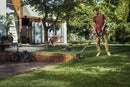 The Husqvarna Aspire™ T28 Grass Trimmer (Kit) features a long, extendable handle and a cutting blade at the end, with ergonomic grips and an orange and black design. A red "POWER FOR ALL" 18V Alliance logo is displayed in the lower left corner, highlighting its versatility as a battery trimmer.