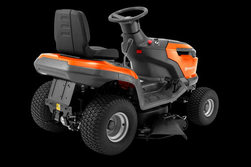 A bright orange Husqvarna TS 114 Lawn Tractor with black seating. This essential tool for maintaining beautiful lawns features large, sturdy wheels, a steering wheel, and various control mechanisms. The brand name and logo are prominently displayed on the front and side.