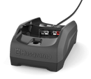 The Husqvarna 40-C80 Battery Charger, in gray, features an attached cable and a slot for the battery, prominently displaying the Husqvarna logo on the front. Designed for efficient charging, this compact single bay charger boasts an angled design, making it ideal for portable use.