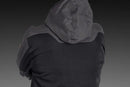 The Husqvarna Xplorer Shell Jacket Charcoal Black - Women by Husqvarna is a dark gray, hooded outdoor jacket. This windproof jacket features a full front zipper, zippered pockets, and subtle branding on the chest. It has long sleeves, adjustable ventilation, and a slightly fitted design, making it suitable for various weather conditions.