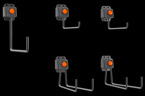 The image showcases the Husqvarna Aspire™ Storage Hook Set by Husqvarna, featuring five black wall-mounted hooks with orange buttons. Each metal hook has multiple prongs extending horizontally from the base, making them perfect for organizing garden tools. The hooks are depicted in various orientations, illustrating different usage positions.