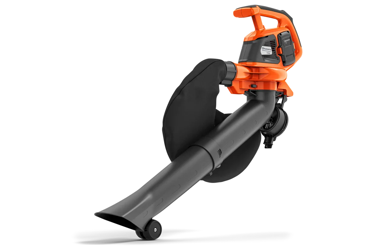 An orange and black Husqvarna 120iBV (kit) with a long nozzle, ergonomic handle, and built-in wheels is designed for easy maneuvering on lawns.