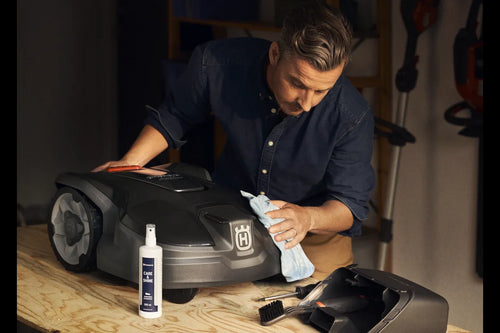 Introducing the Husqvarna Automower Cleaning and Maintenance Kit: This all-inclusive set comes complete with a plastic container, grey dustpan, blue cloth, cleaning spray bottle, handheld brush, small white block, scraper tool, and screwdriver. Perfect for maintaining your Husqvarna automower with ease and keeping it in top condition.