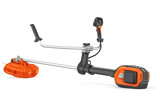 A professional-grade Husqvarna 525iRXT Brushcutter (skin) in orange and silver, featuring a long straight shaft and a protective guard over the cutting blade. The dual handles at the mid-section ensure optimal control, while the powerful motor unit is mounted at the bottom, perfect for forestry tasks.