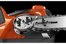 The Husqvarna T542i XP Battery Chainsaw (Skin Only) features an eye-catching orange and black body, a sturdy metal chain bar with the "Husqvarna" brand name displayed on it, a grip handle, and various adjustment controls against a transparent background.