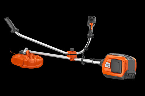 A Husqvarna 325iR Brushcutter (skin) lays on a white background. Perfect for lawns and other outdoor maintenance, the tool features a long silver shaft with a black handle at the top and an orange cutting head at the bottom. The motor is housed in an orange casing near the handle.