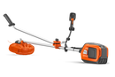 A Husqvarna 325iR Brushcutter (skin) lays on a white background. Perfect for lawns and other outdoor maintenance, the tool features a long silver shaft with a black handle at the top and an orange cutting head at the bottom. The motor is housed in an orange casing near the handle.