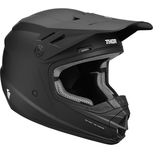 A black THOR MX SECTOR YOUTH HELMET BLACK with a matte finish. Featuring a polycarbonate/ABS shell, this motocross helmet has a visor and prominent chin guard. "Thor" is printed on the side in white letters, and the padded interior, visible through the face opening, includes an EPS liner for added safety. The front has a vent for airflow.