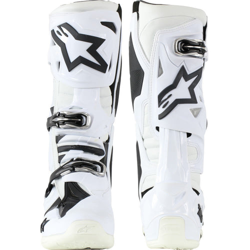 The Alpinestars Tech-10 MX Boots White by Crown Kiwi Enterprises Limited are lightweight motocross boots in white and black, featuring an angular design with multiple buckles, prominent branding, reinforced protective areas, and a Dynamic Heel Compression Protector for style and safety.