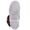 The Alpinestars Tech-3S Kids MX Boots by ALPINESTARS feature black, blue, orange, and neon yellow panels with buckle straps, protective accents, and a white star logo on the shin guard—perfect for young riders seeking style and safety on motocross adventures.