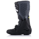 A pair of rugged, high-top black motocross boots with neon green accents. These Alpinestars Tech-5 MX Boots Black/Gray motorcycle accessories feature multiple buckles and straps for secure fastening, a reinforced toe, and a textured design with the ALPINESTARS logo prominently displayed on the front.