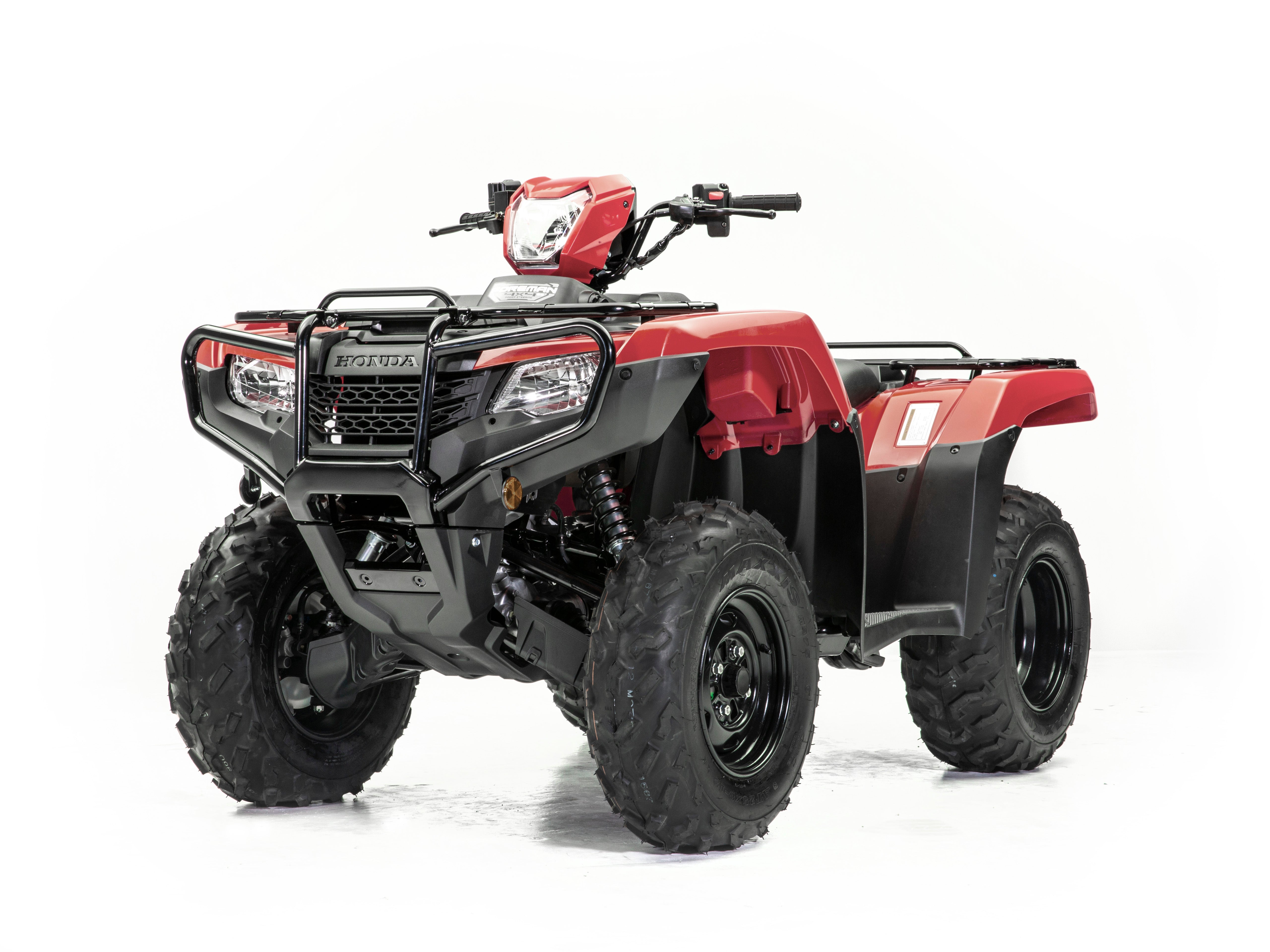 Introducing the Honda TRX520FE2, a red and black all-terrain vehicle (ATV) from the esteemed Honda brand. This robust ATV features durable tires, a protective front bumper, and a sturdy frame, making it perfect for your next adventure. Designed specifically for off-road use, it includes handlebars for precise steering and seating tailored for one rider. The white background accentuates the intricate details of this impressive vehicle.