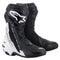 A pair of black and white Alpinestars Supertech R Boots with the ALPINESTARS logo. These racing boots feature a sleek aerodynamic design, reinforced toes, ankle protection, and a blend of matte and glossy finishes, designed for high-performance racing and unmatched protection.