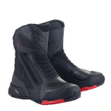 The Alpinestars RT-7 Drystar Boots by Crown Kiwi Enterprises Limited are black motorcycle boots with red accents, offering waterproof performance with reinforced panels and textured soles for grip, ensuring durability and protection during rides.