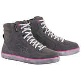 Introducing the Alpinestars J-6 WP Shoes for women by Crown Kiwi Enterprises Limited. These high-top sneakers feature a sleek gray design with pink accents and white laces, perfectly embodying a casual, sporty vibe. The subtle logo on the side adds a touch of style, while the light gray soles enhance the overall color scheme. Designed to be waterproof, these shoes are ideal for urban adventures, keeping your feet dry even in wet conditions.