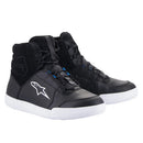 The Alpinestars Chrome Drystar Shoes by ALPINESTARS are black high-tops with white soles and a prominent logo on the sides, designed for urban riders. They feature black laces with blue accents, "Waterproof Drystar®" text, and slightly padded ankle areas for comfort and protection.