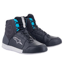 These fashionable Alpinestars Womens Chrome Drystar Shoes by Crown Kiwi Enterprises Limited showcase black and blue paneling with white soles. They are equipped with lace-up fronts and a prominent branded logo on the side, making them the perfect choice for riding shoes with a stylish flair.