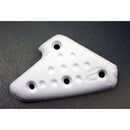 A white, triangular Alpinestars Tech-8 Kick Start Protector by ALPINESTARS, featuring multiple holes and a subtle curve, lies on a dark gray backdrop. It has a textured surface with a delicate design.