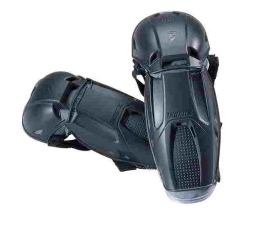 A black shin guard with adjustable straps, designed to provide protection to a youth player's shins and knees. These ELBOW GUARD THOR QUADRANT YOUTH guards by THOR MX feature a sturdy plastic shell with cushioned interiors, moisture-wicking materials, and a textured area for added grip.