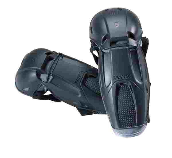 A black shin guard with adjustable straps, designed to provide protection to a youth player's shins and knees. These ELBOW GUARD THOR QUADRANT YOUTH guards by THOR MX feature a sturdy plastic shell with cushioned interiors, moisture-wicking materials, and a textured area for added grip.
